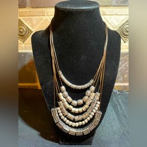 NWT necklace with brown cords and silver beads it is 16” with 4 inch extender